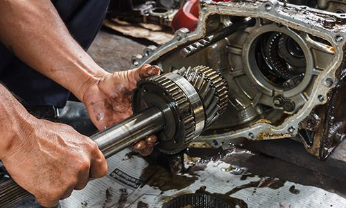 A mechanic working on a car engine